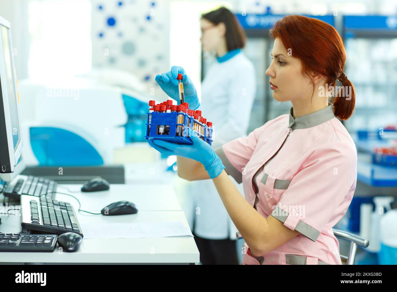 Lab technician holding test tubes and doing researches in laboratory. Stock Photo