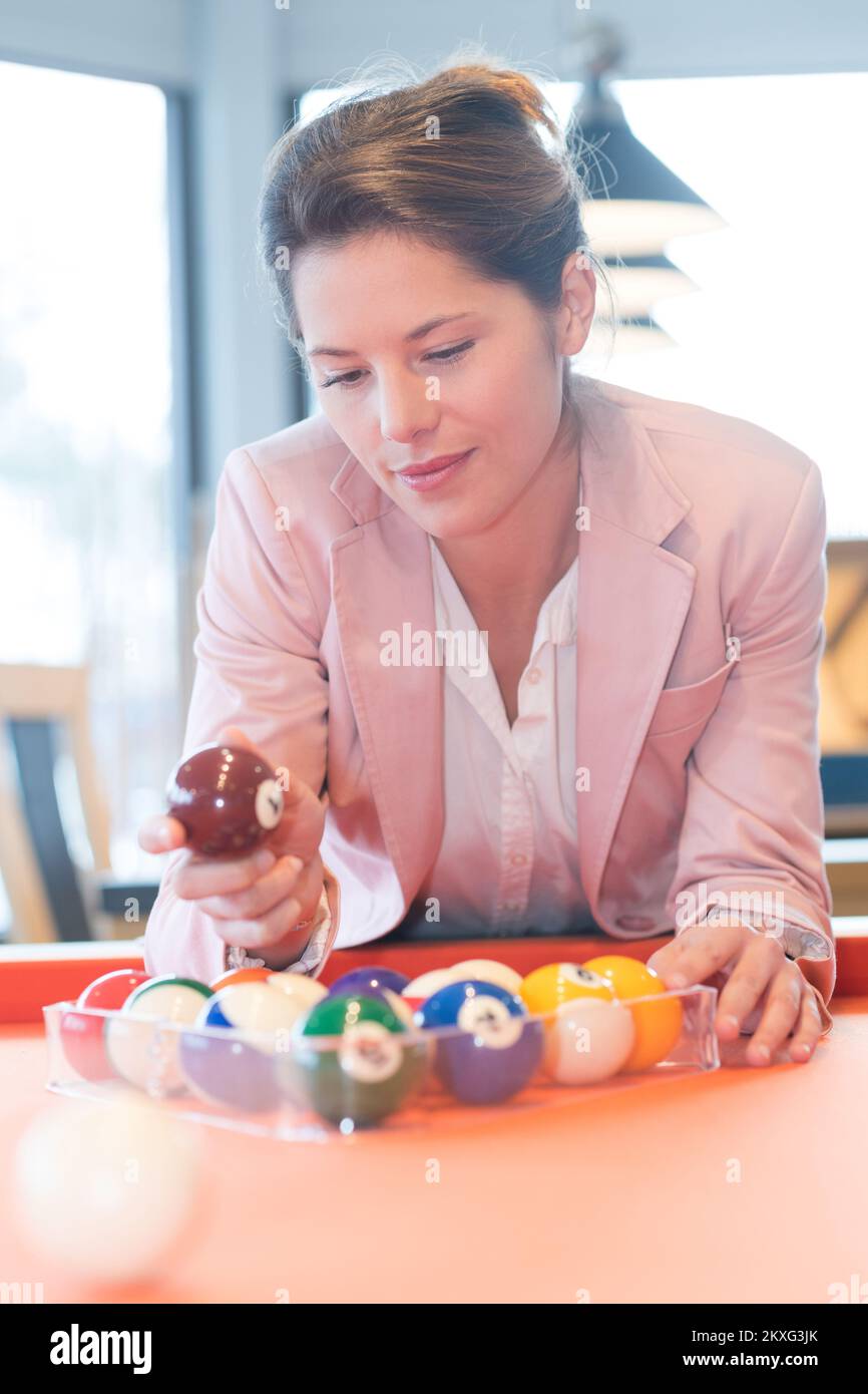 woman setting up pool balls in transparent triangle frame Stock Photo