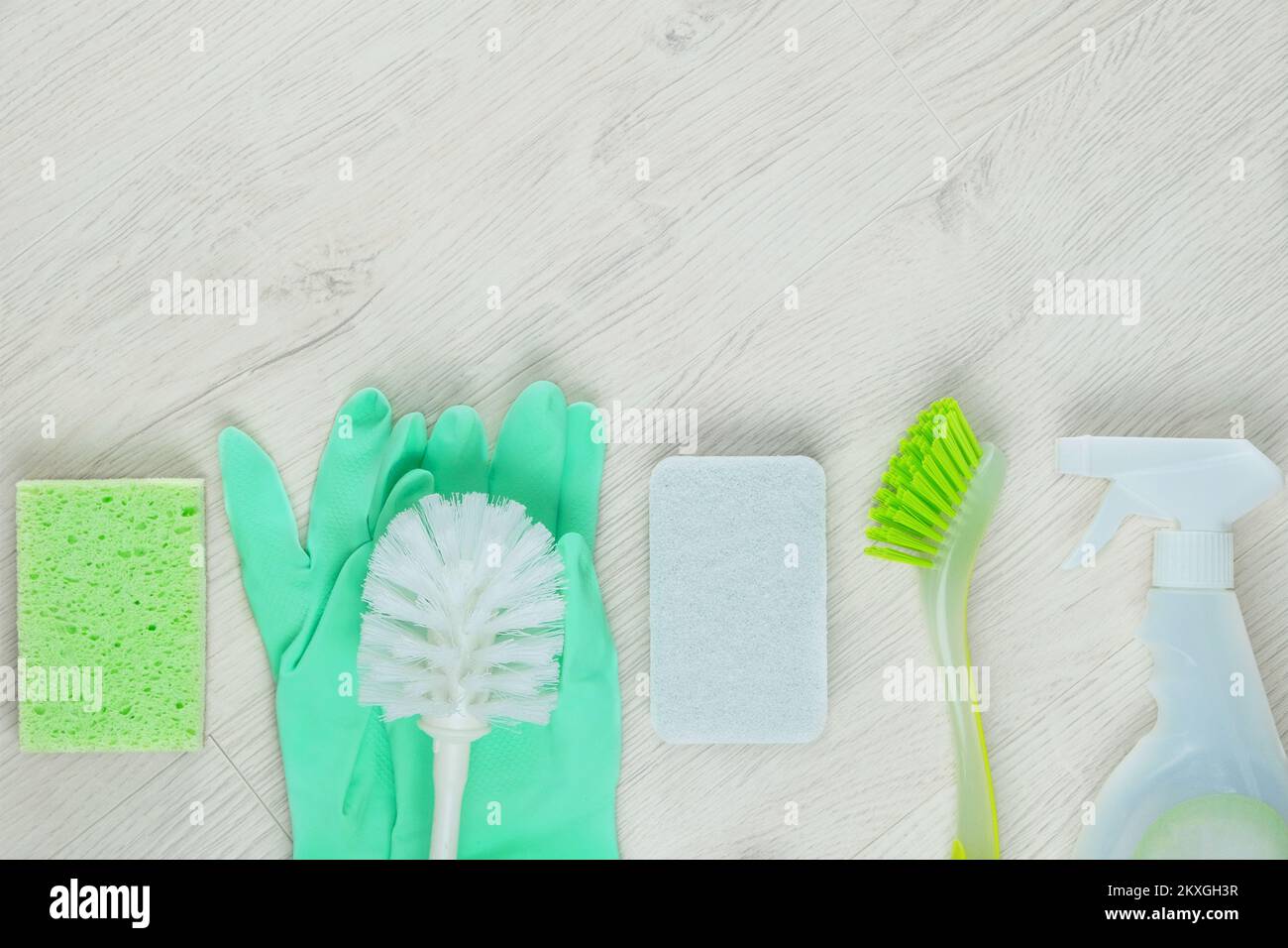 Stack of cleaning sponges and bottle with a cleaning agent. Service concept and cleaning accessories. Stock Photo