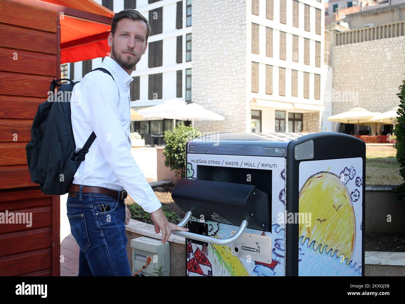 Three Big Belly Solar Compactor waste and recycling bins set up on