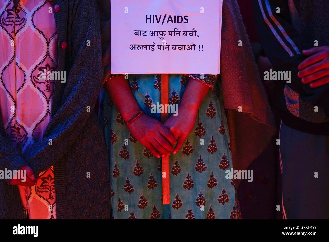 A placard held by a member from Maiti Nepal, a rehabilitation center ...