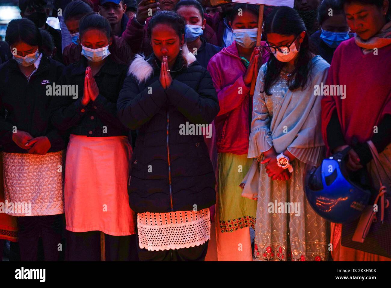 Kathmandu, Nepal. 30th Nov, 2022. People from Maiti Nepal, a rehabilitation center for victims of trafficking and home for the HIV-affected, stand for a minute of prayers in memory of those lives lost to HIV around a red ribbon on the eve of World AIDS Day. World AIDS Day is observed every year on December 1st to raise awareness and support for those living with HIV/AIDS. (Photo by Skanda Gautam/SOPA Images/Sipa USA) Credit: Sipa USA/Alamy Live News Stock Photo