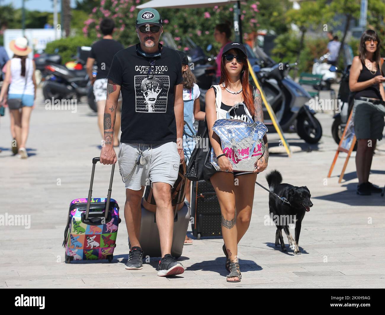 Tourists with suitcases and bags leave the city, in Sibenik, Croatia, August 21,2020.Several countries, and those from which most tourists come to us, have put Croatia (or some parts of it) on the red lists. It is about Austria, which was the first to declare Croatia a risky country, Germany put two Dalmatian counties on the red list –Sibenik-Knin and Split-Dalmatia.Slovenia and United Kingdom also put Croatia on the red list.Although the change of tourists in “normal” circumstances would be expected only on weekends, due to putting Croatia on the red lists, tourists have already started leav Stock Photo