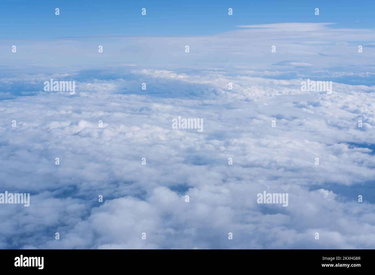 Background of a pink blue heavenly sky with fluffy dense clouds, top view from an airplane. Sky Gradient. Can be used as advertising background, overl Stock Photo