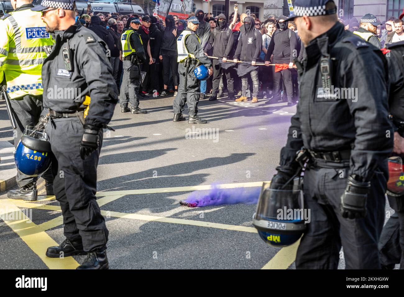 Antifa opposing protest to a Democratic Football Lads Alliance, DFLA, march towards Parliament, London, UK, in a protest. Thrown smoke flare Stock Photo