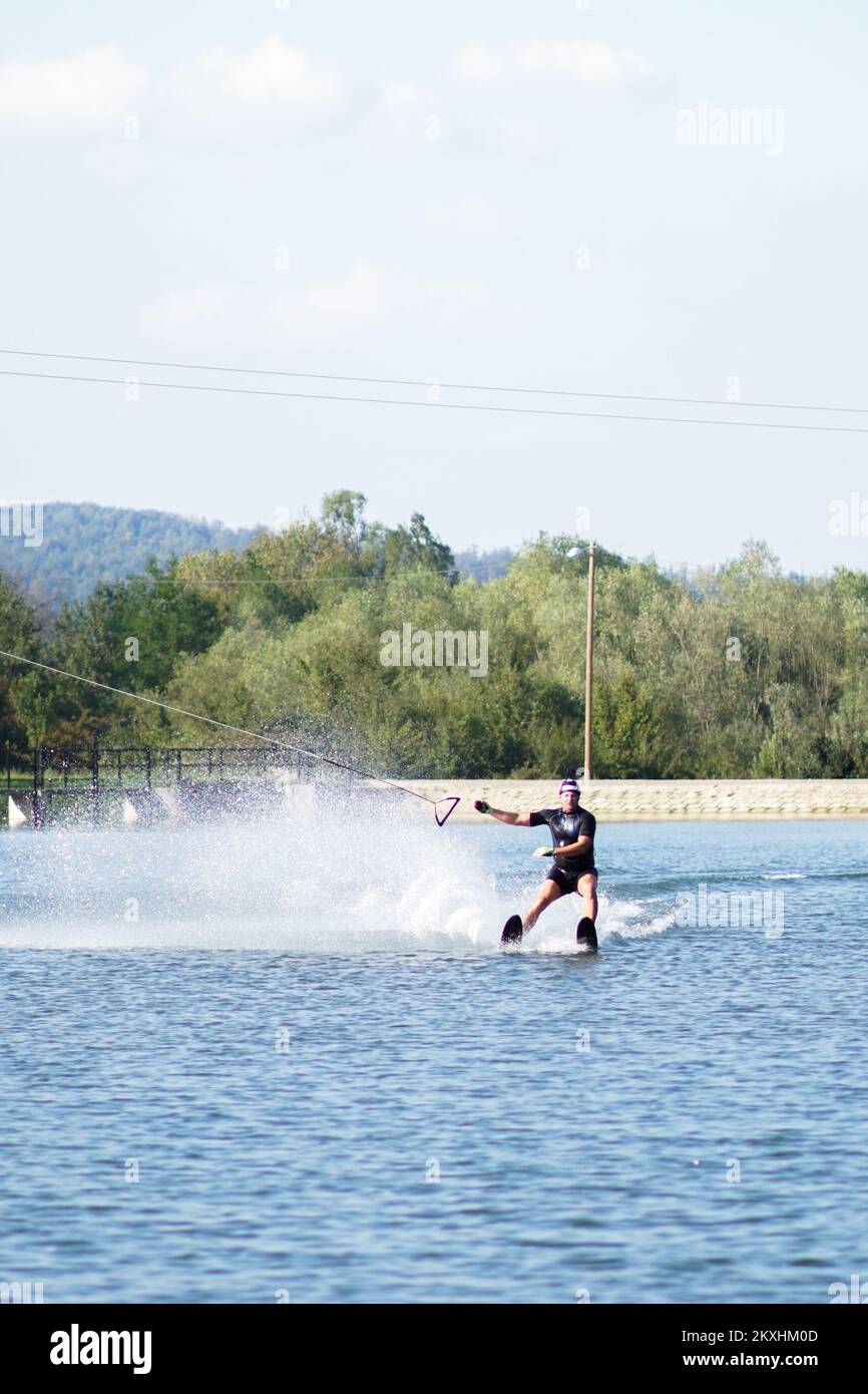 A man seen skiing on water at the Manjaca Tourist and Recreation Center near Banja Luka, Bosnia and Herzegovina on September 14, 2020. Visitors to Lake Manjaca within the eponymous tourist and recreational center now have access to adrenaline skiing, or water skiing. From 'Wake Park' they say that this skiing is a unique experience where with the help of a cable car you slide on the surface of the water, with a maximum speed of 32 km/h, at a length of 282 meters, which makes it the longest line in Europe. The park has lifeguards and trained operators for Wake boarding. Photo: Dejan Rakita/PIX Stock Photo