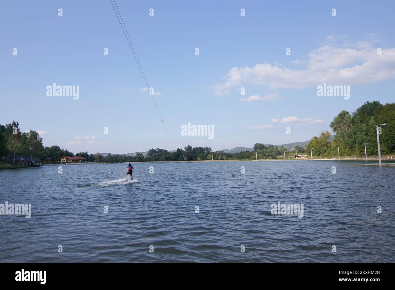 A man seen skiing on water at the Manjaca Tourist and Recreation Center near Banja Luka, Bosnia and Herzegovina on September 14, 2020. Visitors to Lake Manjaca within the eponymous tourist and recreational center now have access to adrenaline skiing, or water skiing. From 'Wake Park' they say that this skiing is a unique experience where with the help of a cable car you slide on the surface of the water, with a maximum speed of 32 km/h, at a length of 282 meters, which makes it the longest line in Europe. The park has lifeguards and trained operators for Wake boarding. Photo: Dejan Rakita/PIX Stock Photo