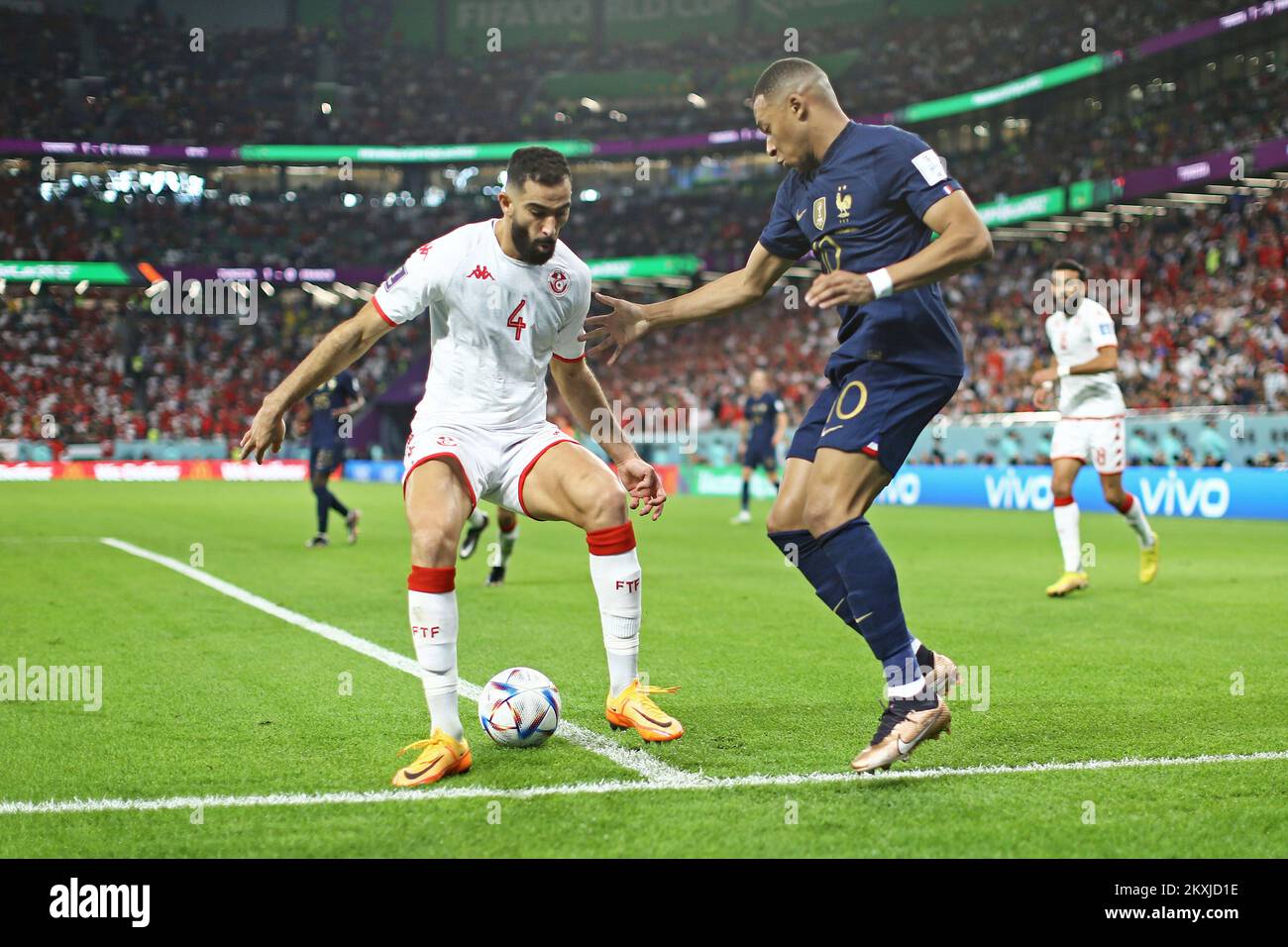 Doha, Qatar. 30th Nov, 2022. Yassine Meriah of Tunisia disputes the bid with Kylian Mbappe of France, during the match between Tunisia and France, for the 3rd round of Group D of the FIFA World Cup Qatar 2022, Education City Stadium this Wednesday 30. 30761 (Heuler Andrey/SPP) Credit: SPP Sport Press Photo. /Alamy Live News Stock Photo