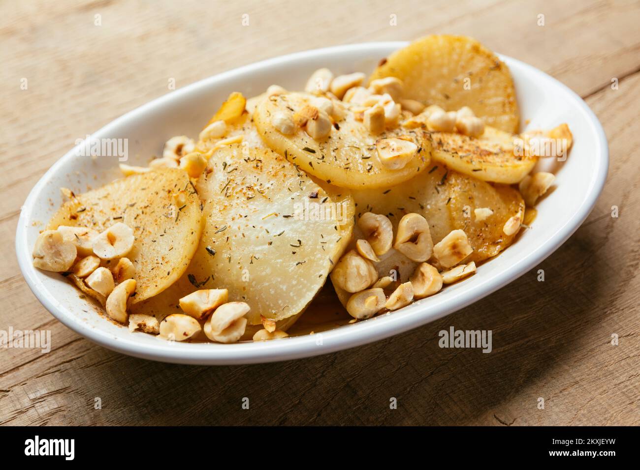 Fried white turnip slices with roasted hazelnuts Stock Photo Alamy