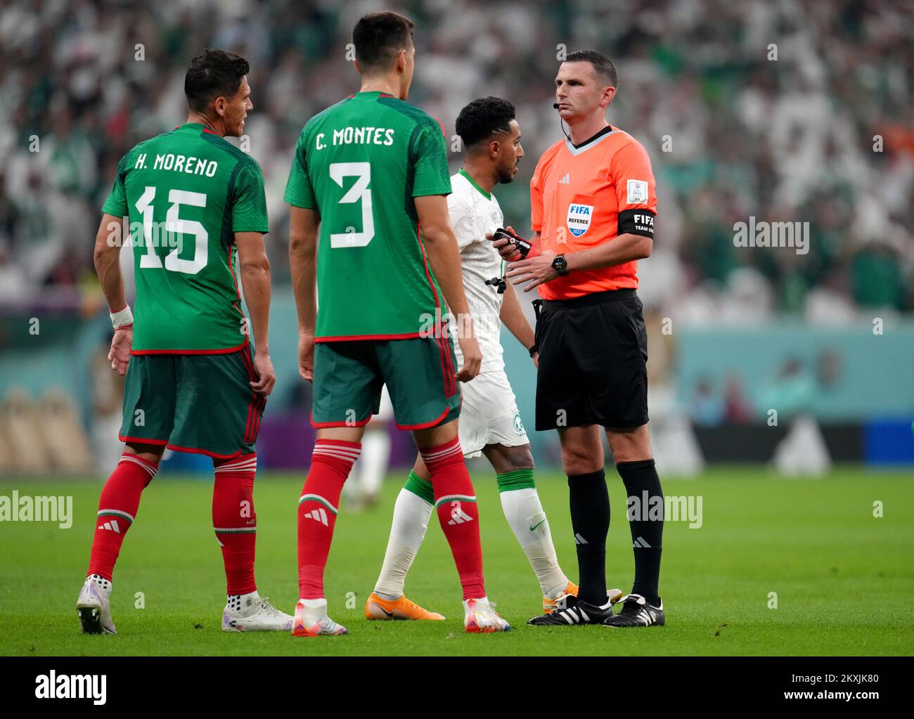 Match referee Michael Oliver speaks to Mexico's Hector Moreno and Cesar Montes during the FIFA World Cup Group C match at the Lusail Stadium in Lusail, Qatar. Picture date: Wednesday November 30, 2022. Stock Photo