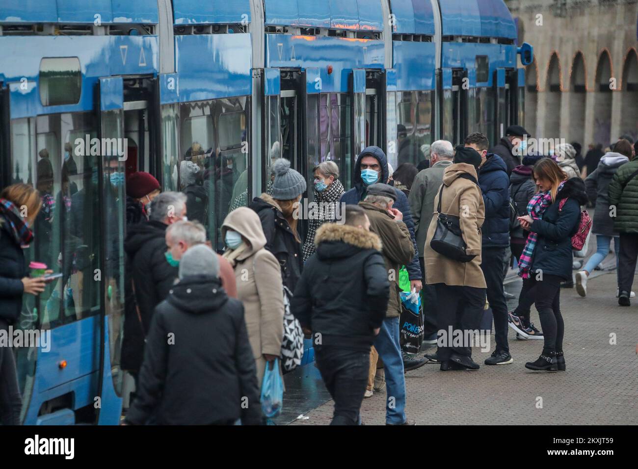 Passengers enter and exit a tram with a protective mask in Zagreb, Croatia on November 28, 2020. According to the new measures, which came into force at midnight, the occupancy rate in public transport must not exceed 40 percent of the available seats, and carriers are obliged to point out the maximum number of passengers allowed in the means of transport. In the last 24 hours, 3,987 new cases of coronavirus infection were recorded in Croatia. Photo: Sanjin Strukic/PIXSELL Stock Photo