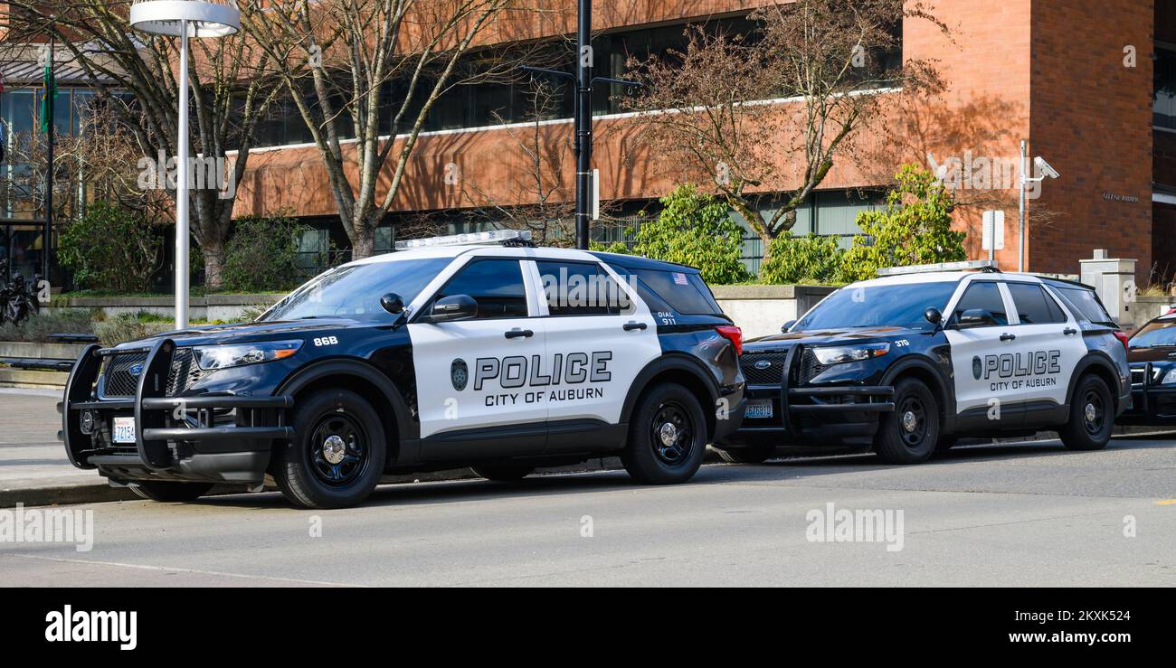 Auburn, WA, USA - January 21, 2022; Two City of Auburn police cars in the Washington state city parked alongside the curb Stock Photo