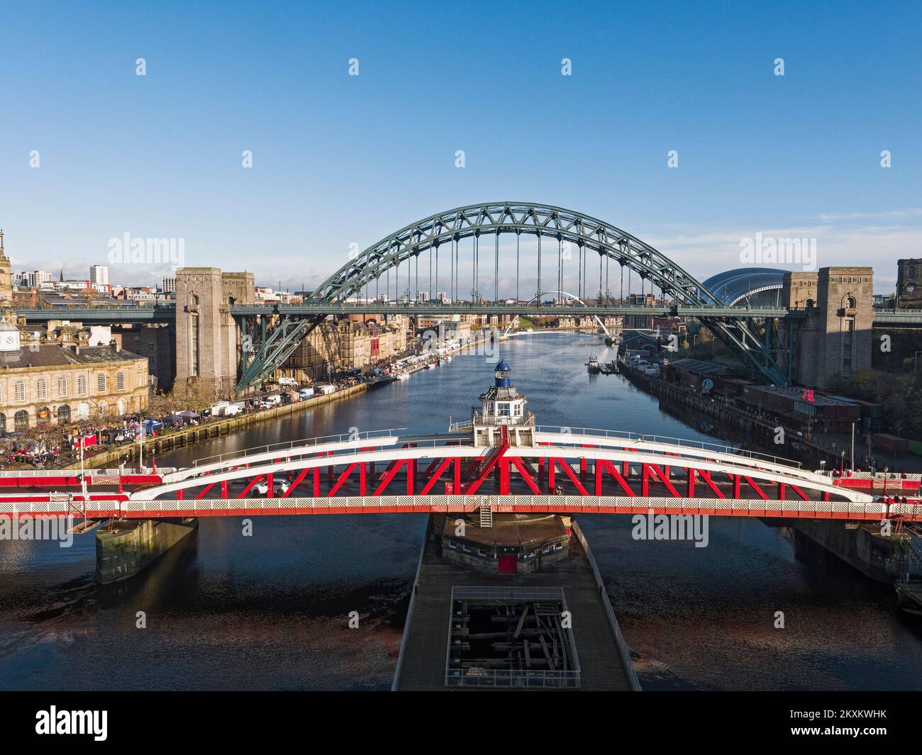 View over Newcastle upon Tyne, UK quayside with Swing and Tyne bridges, and Sunday market. Stock Photo