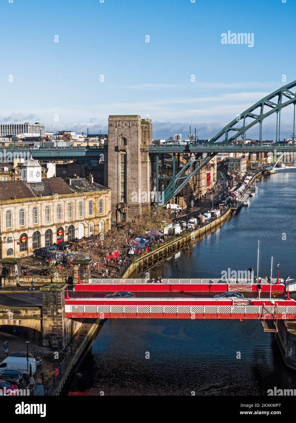 View over Newcastle upon Tyne, UK quayside with Swing and Tyne bridges, and Sunday market. Stock Photo