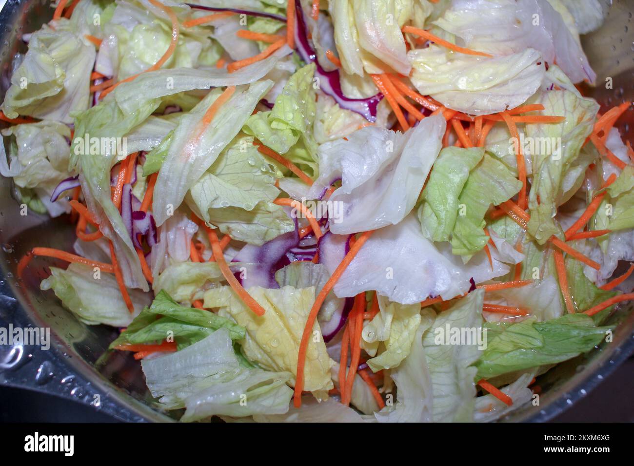 healthy salad with lettuce and carrot and olive oil Stock Photo