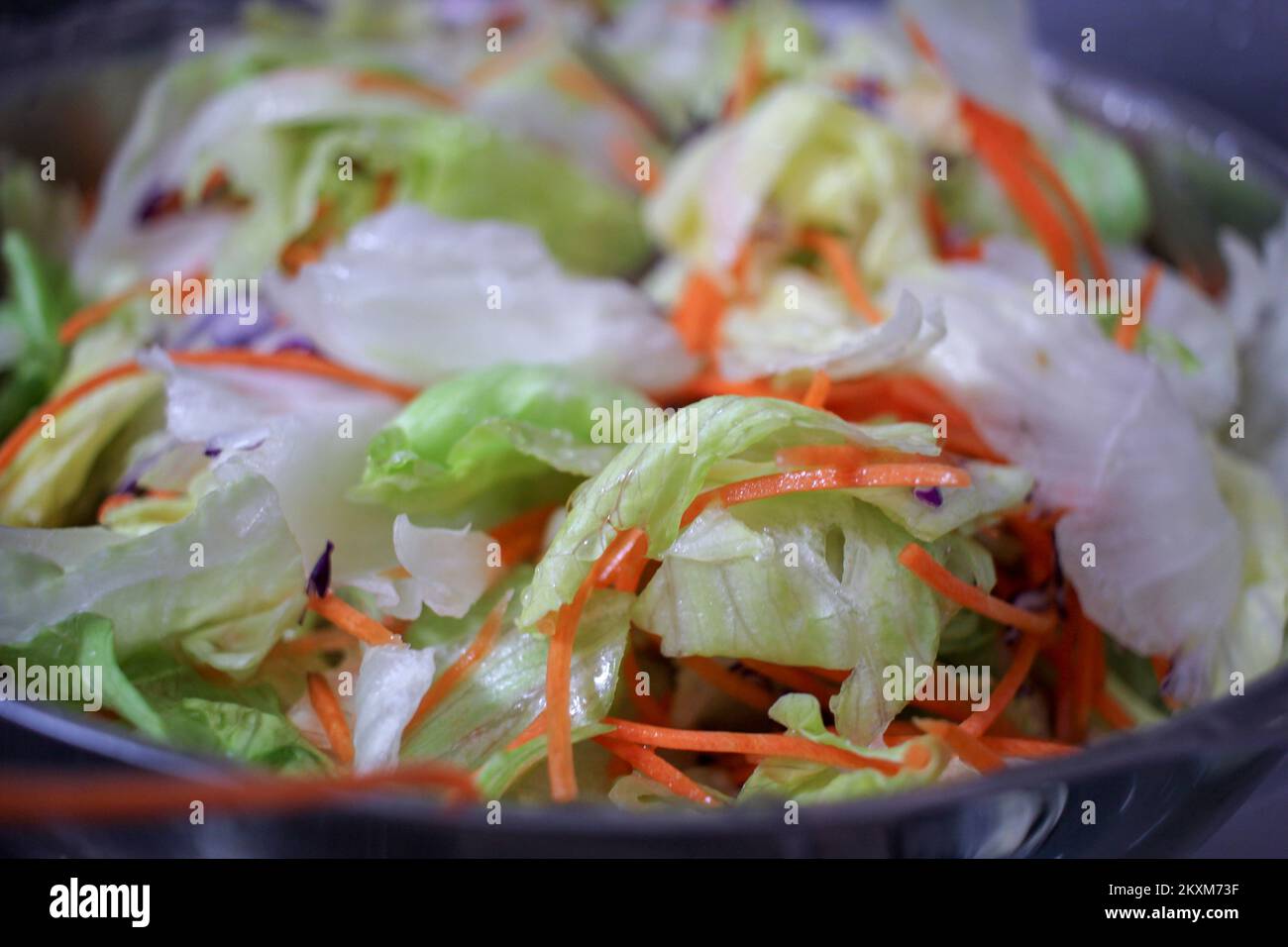 the benefits of eating healthy salads with olive oil, lettuce and carrot Stock Photo