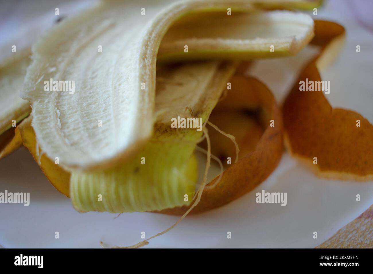 a plate full of skins from bananas and apples after lunch Stock Photo