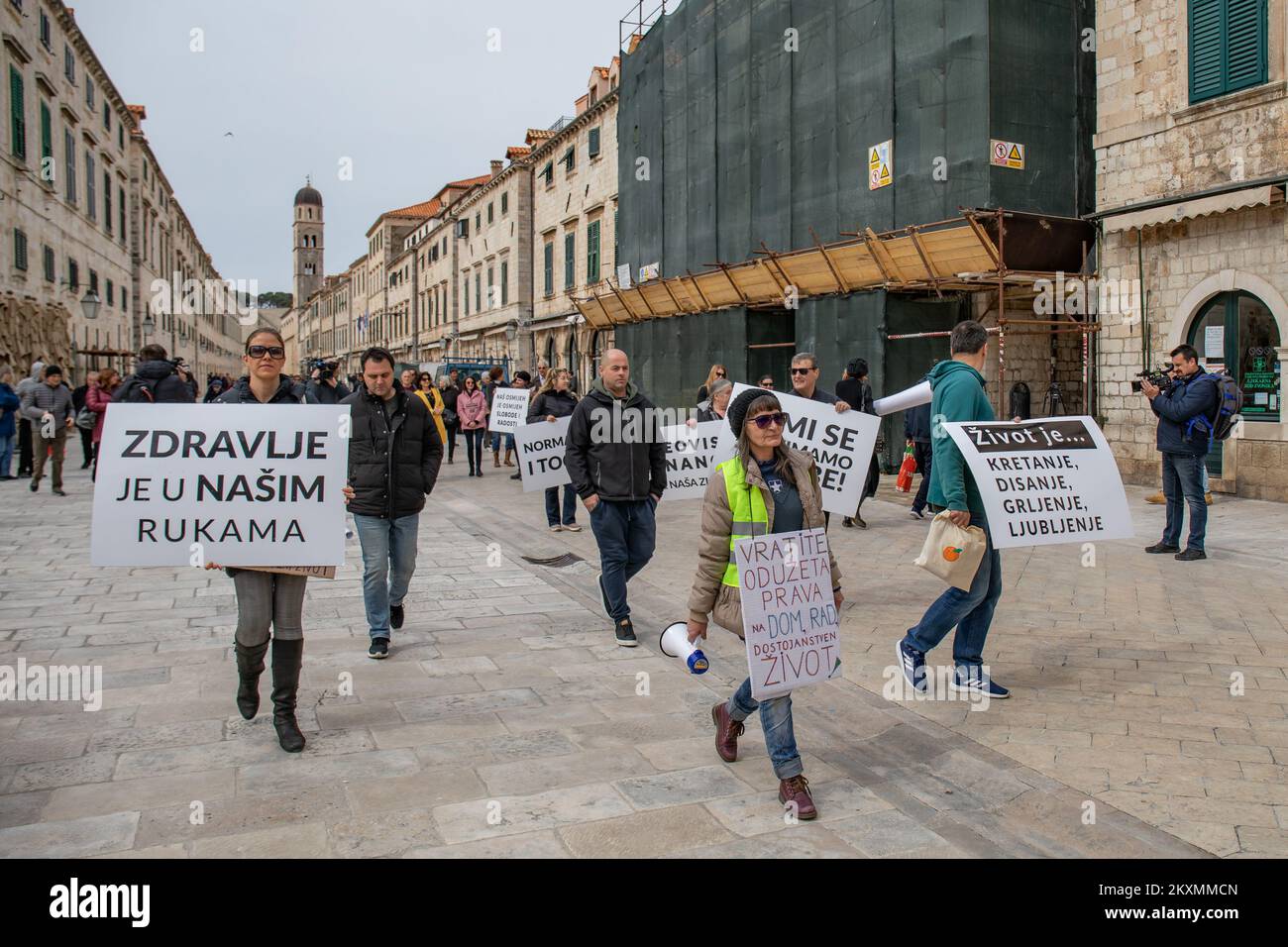 Demonstrators walk and hold up placards during global 'World Wide Rally for Freedom' protest campaign to denounce COVID-19-related restrictions and vaccination rollout plans in Dubrovnik, Croatia on March 20, 2021. Photo: Grgo Jelavic/PIXSELL Stock Photo