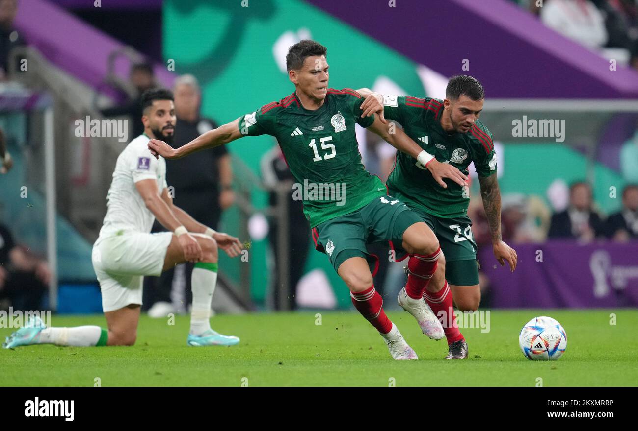 Mexico's Hector Moreno (left) and Luis Chavez almost tackle each other during the FIFA World Cup Group C match at the Lusail Stadium in Lusail, Qatar. Picture date: Wednesday November 30, 2022. Stock Photo