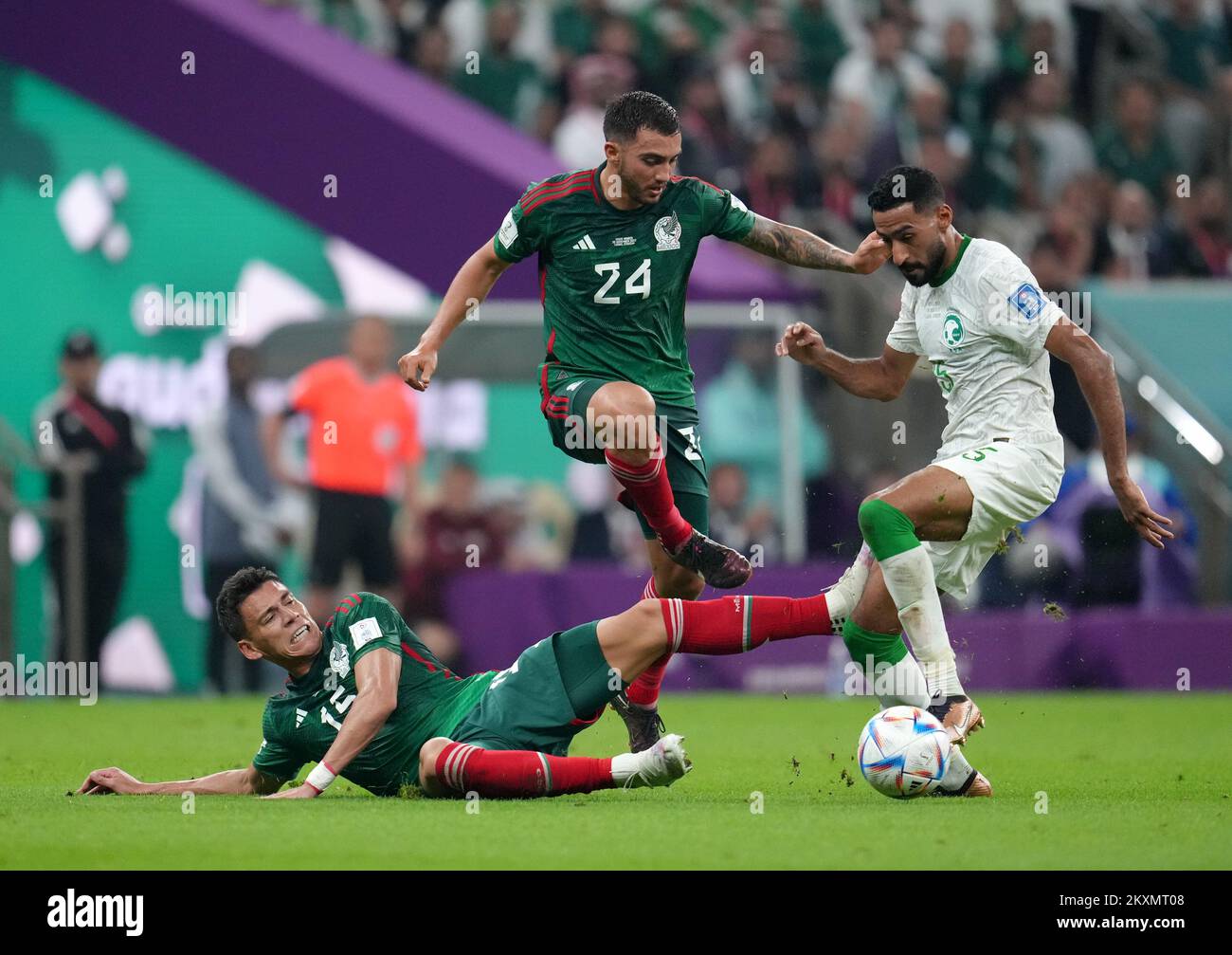 Saudi Arabia's Ali Al-Hassan (right) battles with Mexico's Hector Moreno (left) and Luis Chavez during the FIFA World Cup Group C match at the Lusail Stadium in Lusail, Qatar. Picture date: Wednesday November 30, 2022. Stock Photo