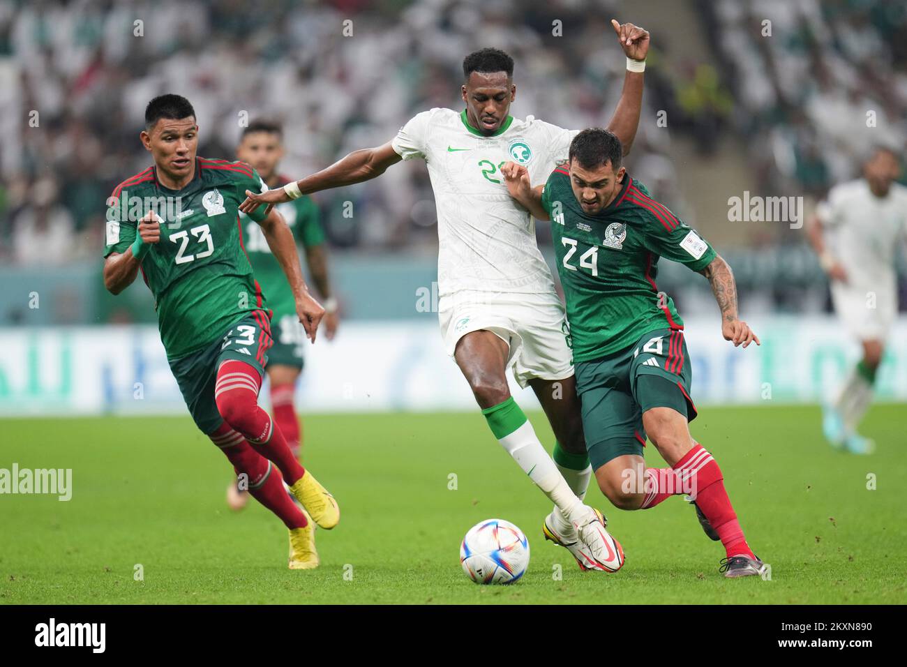 Lusail, Qatar. 30th Nov, 2022. Mohamed Kanno (2nd R) of Saudi Arabia vies with Luis Chavez (1st R) of Mexico during the Group C match between Saudi Arabia and Mexico at the 2022 FIFA World Cup at Lusail Stadium in Lusail, Qatar, Nov. 30, 2022. Credit: Meng Dingbo/Xinhua/Alamy Live News Stock Photo