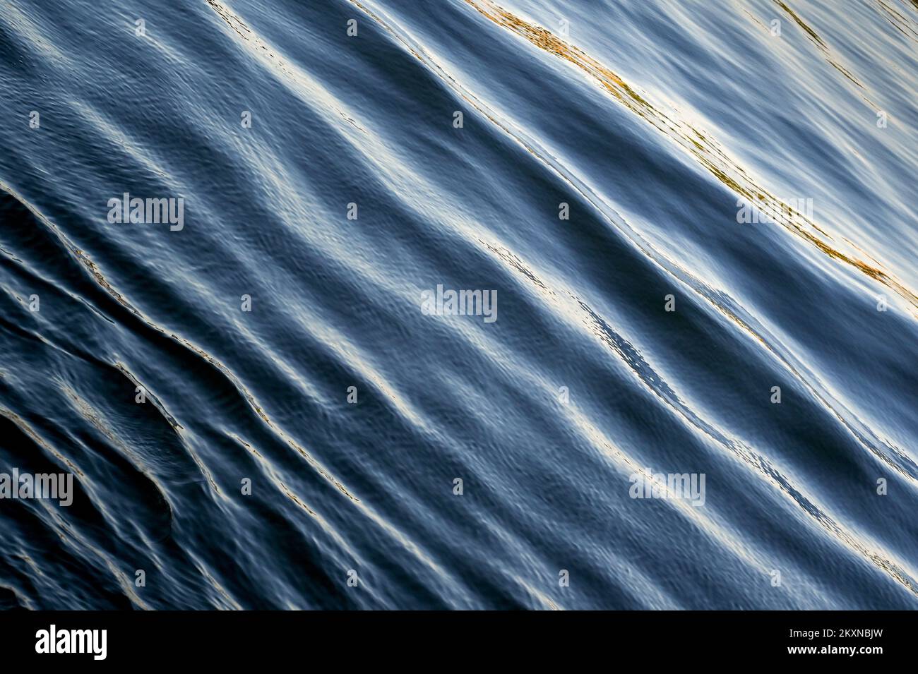 Ripples on blue sea from a passing boat. backgrounds, No people. Copy space. Stock Photo