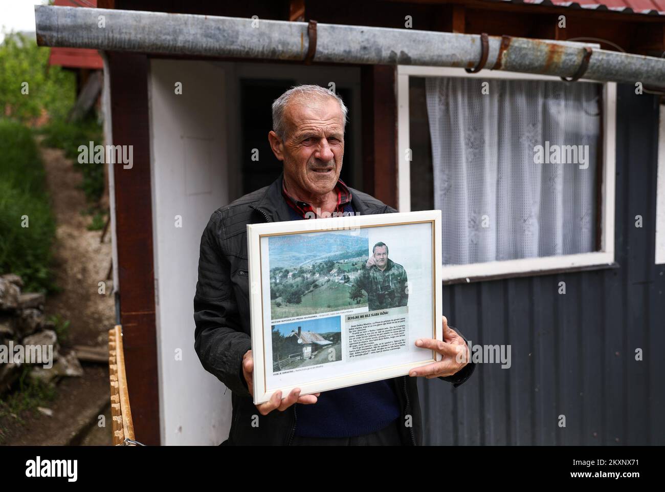 Zoran Mladic in front of the house with photos of his cousin Ratko Mladic, in Bozanovici, Bosnia and Herzegovina, on June 07, 2021. The village of Bozanovici near Kalinovik is the birthplace of war criminal Ratko Mladic. The villagers still support the war criminal Ratko Mladic and they hope that the court in The Hague will acquit him of all charges. The final verdict against Ratko Mladic, former commander of the Republika Srpska Army's (VRS) General Staff, who is charged with the most serious war crimes committed in Bosnia and Herzegovina (1992-1995), including genocide, will be handed down o Stock Photo