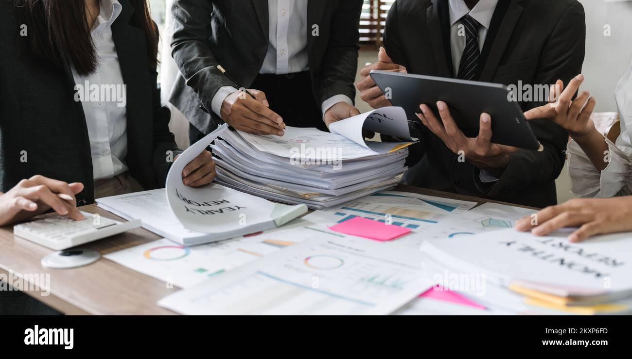 diverse coworkers working together in boardroom, brainstorming, discussing and analyzing and planning business strategy. Stock Photo