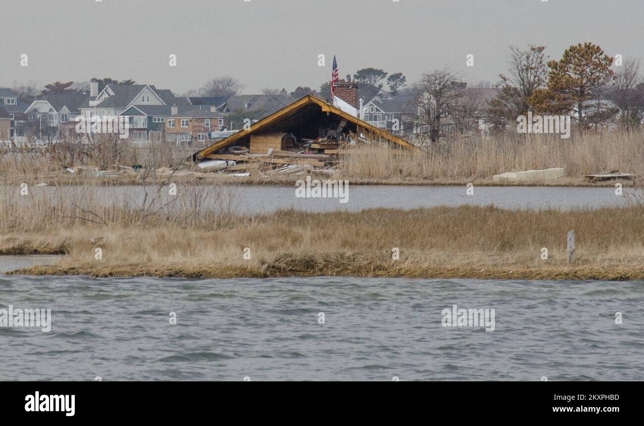 Mantoloking, N.J., Feb. 25, 2012   A rooftop landed in a marshy area in Barnegat Bay after blowing off a house during Hurricane Sandy. New Jersey Hurricane Sandy. Photographs Relating to Disasters and Emergency Management Programs, Activities, and Officials Stock Photo