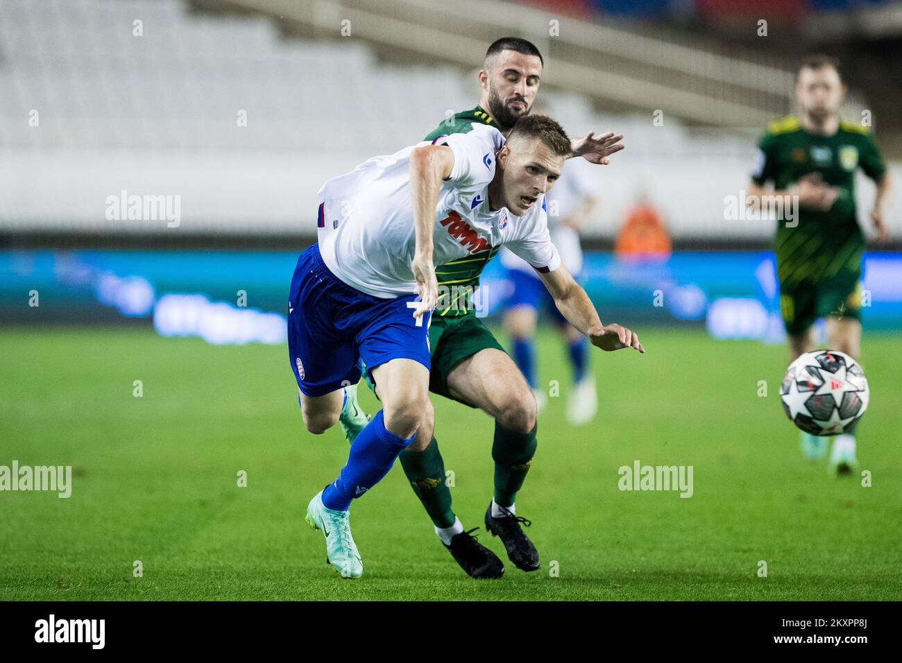 BUDAPEST, HUNGARY - JULY 13: Aleksa Amanovic of FC Tobol challenges  Kristoffer Zachariassen of Ferencvarosi TC during the UEFA Champions League  2022/23 First Qualifying Round Second Leg match between Ferencvarosi TC and