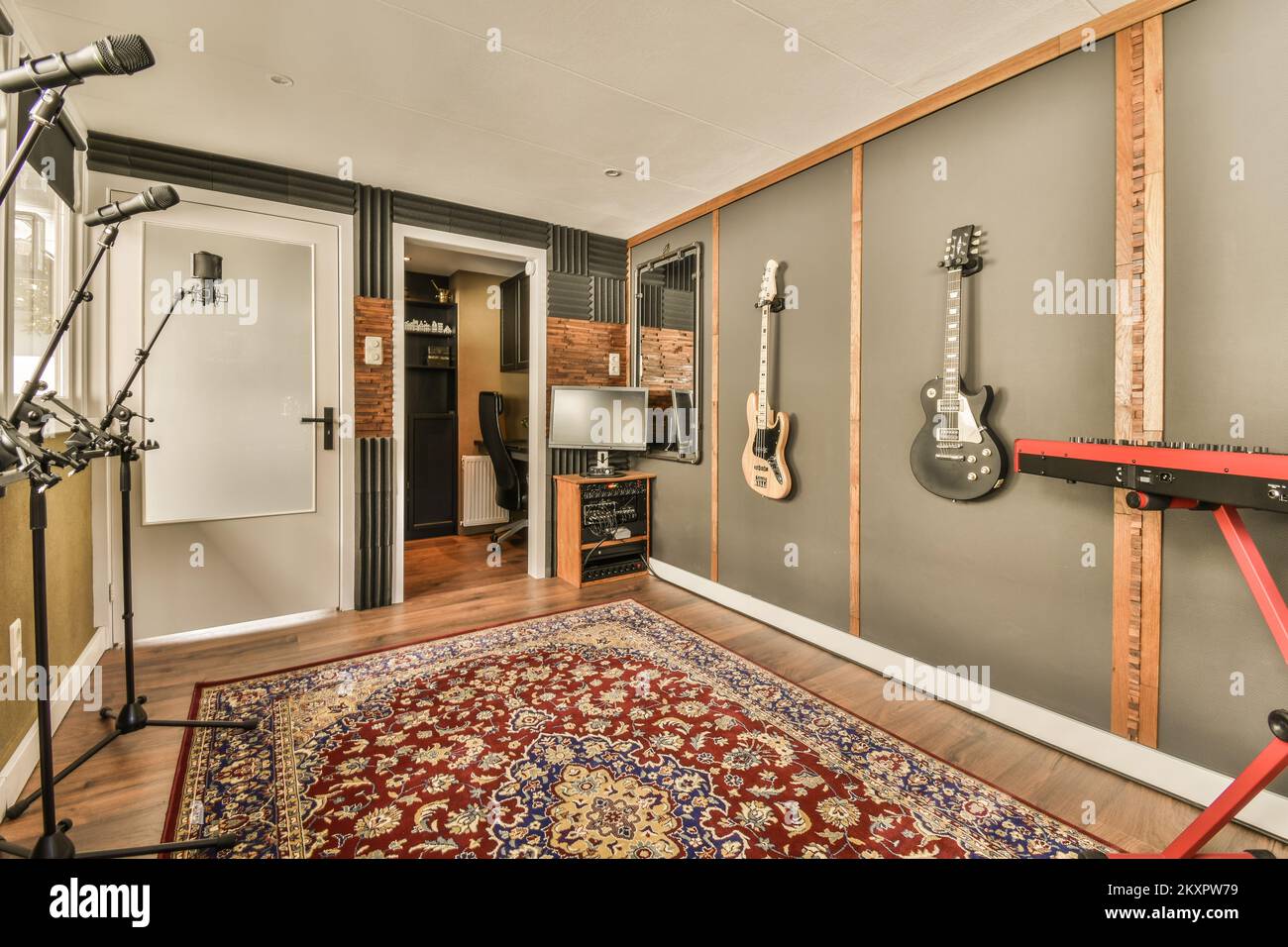 Interior of modern music studio with musical instruments on soft carpet near windows in cozy light room Stock Photo