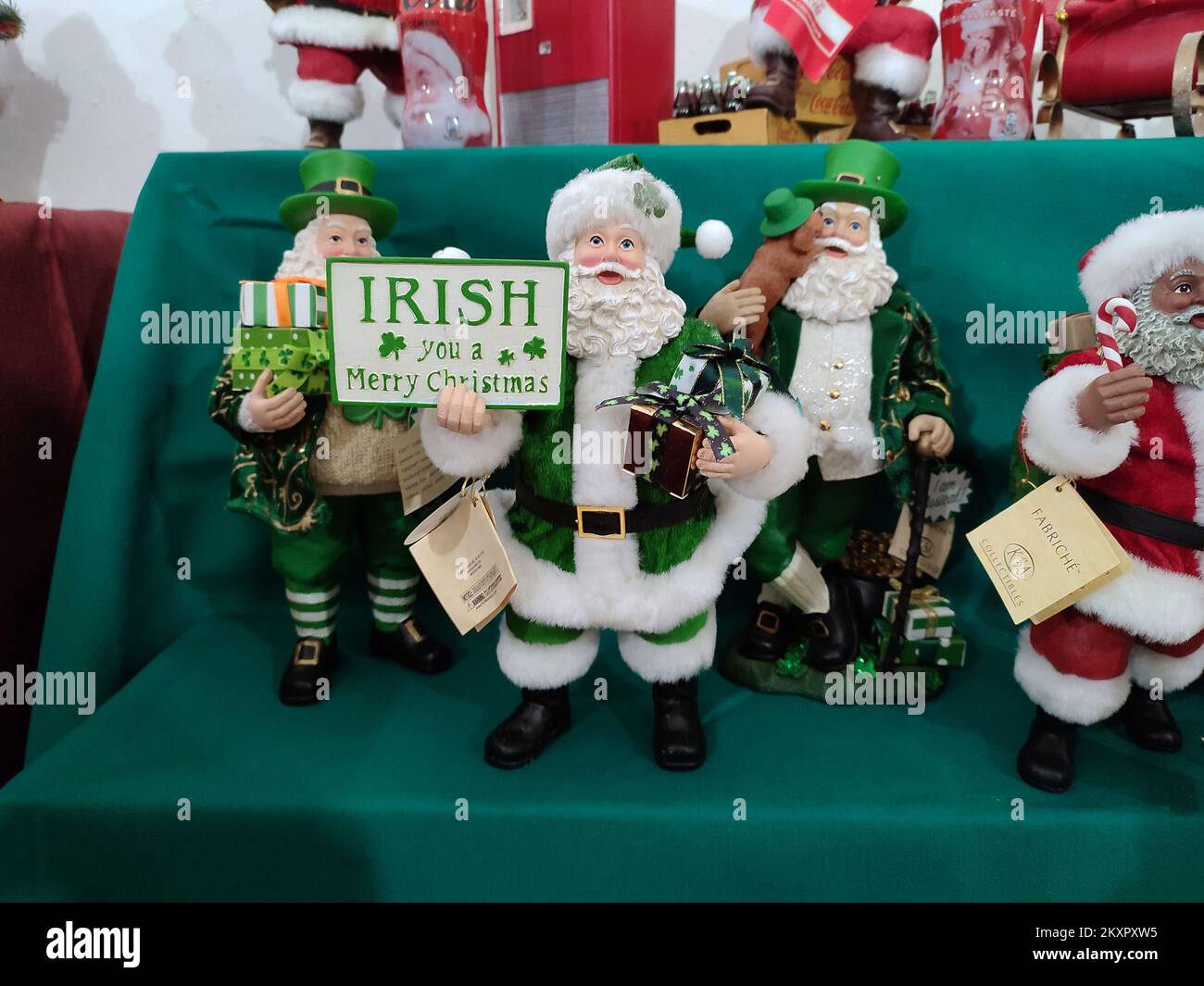 Irish puppets or dolls wish a Merry Christmas dressed in green in a