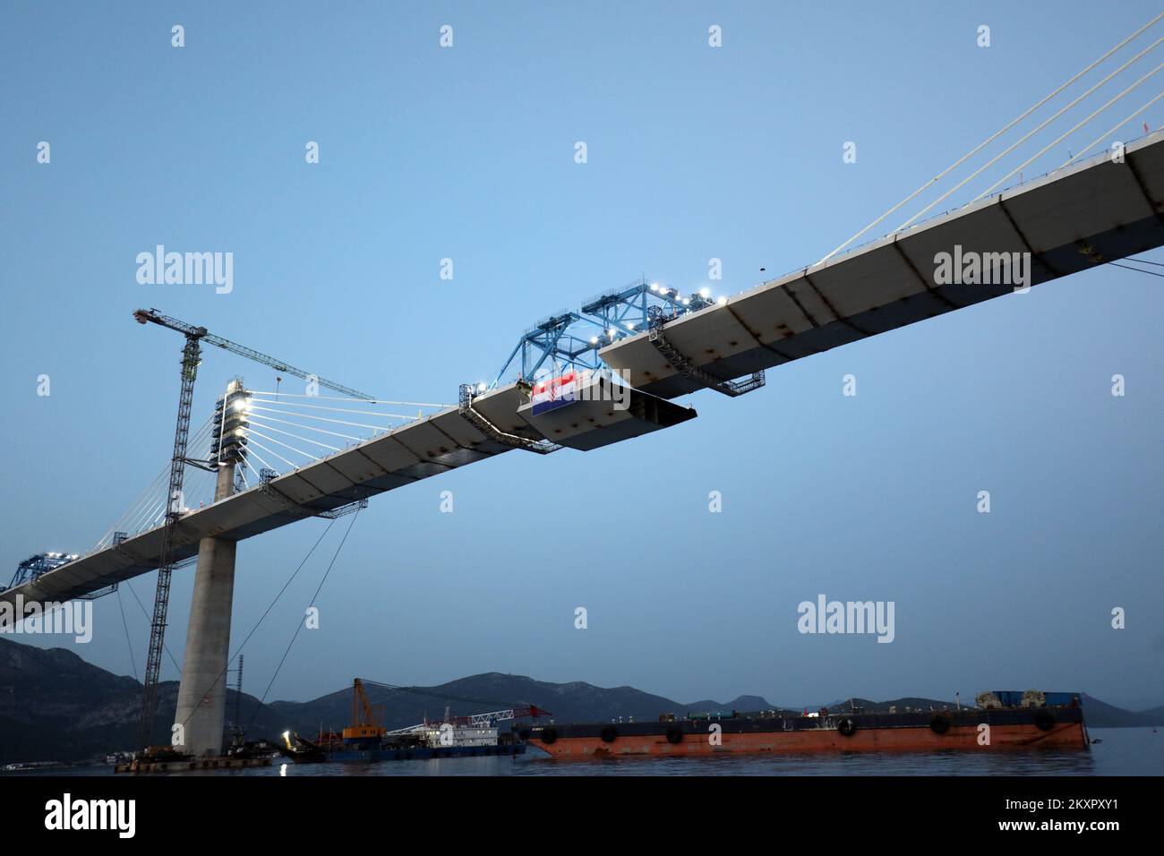 With the installation of the last, 165th segment of the steel span of the Peljesac Bridge on Wednesday evening, the bridge will be finally joined together from Komarna to Brijesta and provide a long-awaited road link between the southernmost part of Croatia with the rest of the country, a project that was neither easy nor without obstacles. Work on the 2.4-kilometer bridge, connecting Croatiaâ€™s Peljesac peninsula with the mainland to bypass a short stretch of the Bosnian coastline at the town of Neum started three years ago. The project is worth â‚¬550 million. The bridge was build by Chine Stock Photo