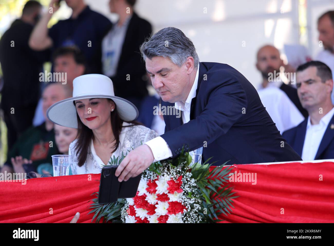 Croatian president Zoran Milanovic with his wife Sanja Music Milanovic during the famous knight's game Sinjska Alka that was held for the 306th time in Sinj on August 8, 2021. Alka is the last stage of the competition after Bara and Coja. Alka is a competition in which alkars ride horses to throw an alka spear. The Alkar competition is conducted in such a way that the Alkar on horseback in a full race spears a spear that hangs in the middle of a rope stretched horizontally between two pillars attached to the edges of the racetrack. Each alkar wears an antique knight's uniform in the most beau Stock Photo