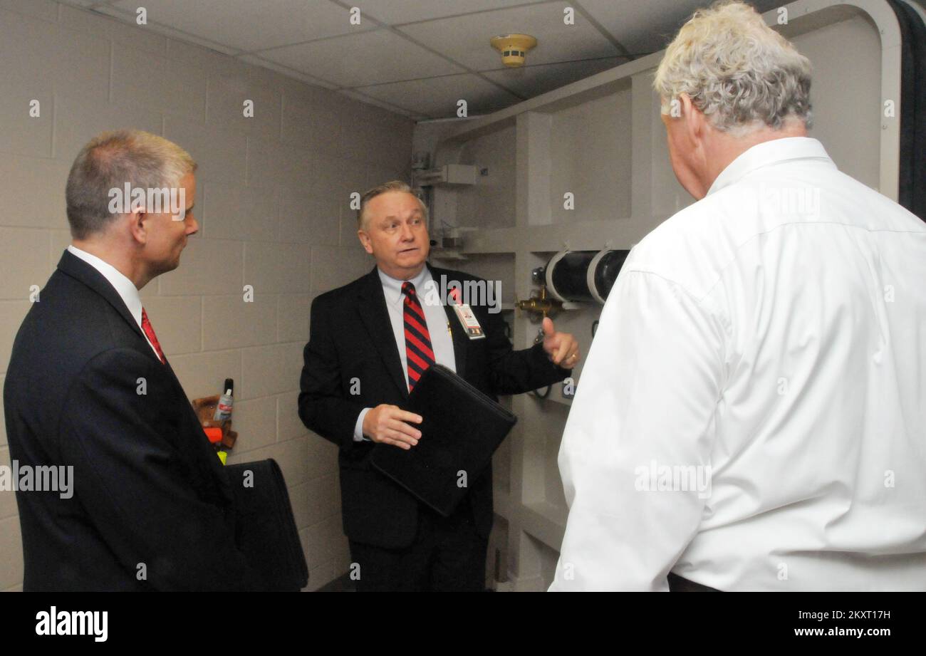 Emergency Planning and Security   Flooding - Houston, Texas, June 28, 2012   Acting FEMA Region 6 Administrator Tony Robinson, left, and FEMA Dep. Administrator Rich Serino, right, listen as Bert Guminger, Dir. of Facilities, Operations and Security at Texas Children's Hospital, explains the workings of a 'submarine door' during a tour of the Texas Medical Center.  .. Photographs Relating to Disasters and Emergency Management Programs, Activities, and Officials Stock Photo