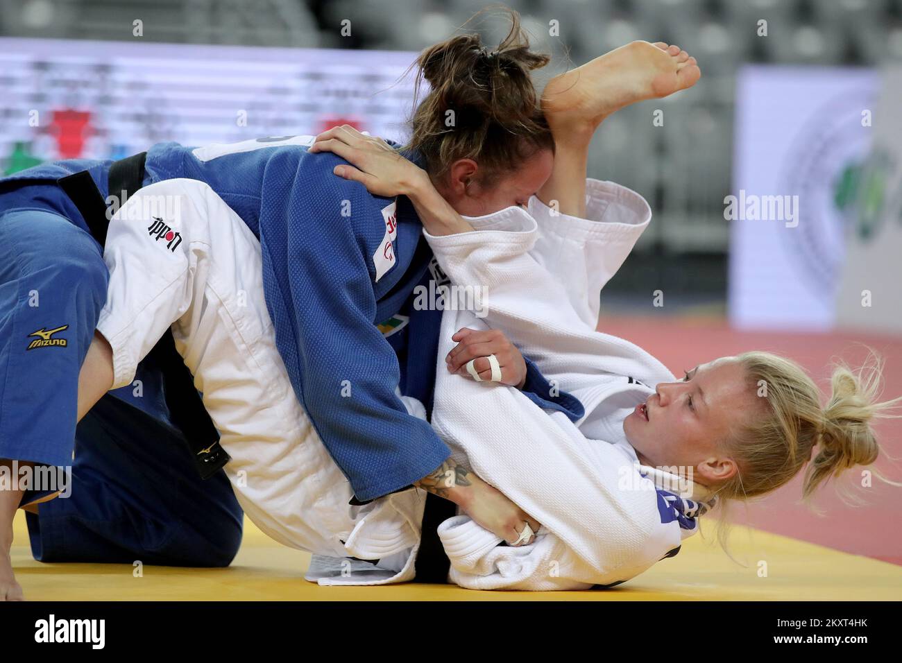 Natasha Ferreira of Brazil and Melanie Vieu of France (blue) compete in ...