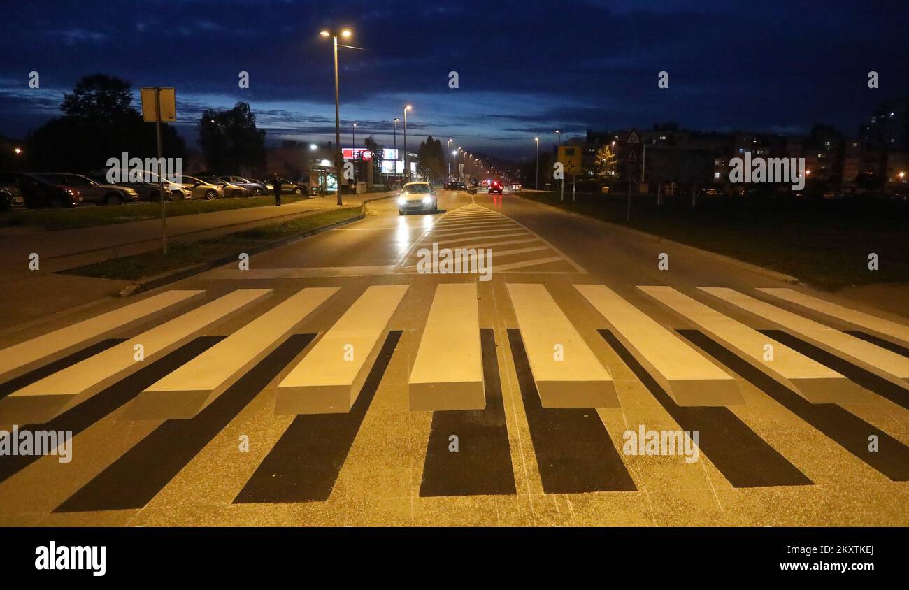 Photo taken on October 19, 2021 shows an innovative 3D pedestrian crossings in King Peter Kresimir IV Street, in Karlovac, Croatia. The striped crossing appears to be floating above the road, creating an optical illusion that is visible to oncoming drivers from both directions. The aim is for the crossing to appear more clearly to drivers so that they slow down when approaching it. Photo: Kristina Stedul Fabac/PIXSELL Stock Photo