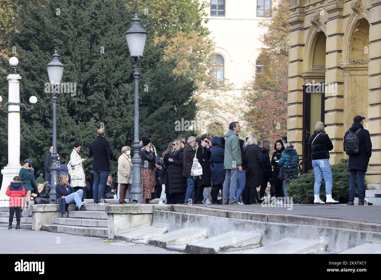 People seen waiting in line in front of Croatian National Theatre to