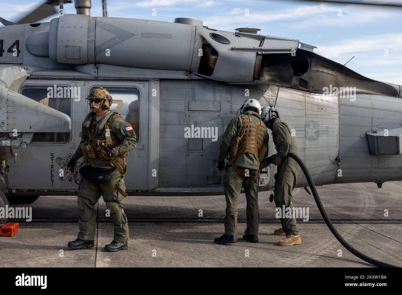 U.S. Marine Corps Cpl. Alexander Berg (right), a loadmaster with Marine Aerial Refueler Transport Squadron (VMGR) 252, and U.S. Sailors with Helicopter Sea Combat Squadron (HSC) 28 refuel a U.S. Navy MH-60S Seahawk via air-delivered ground refueling at Blackstone Army Airfield, Virginia, Nov. 16, 2022. VMGR-252 provided assault support to Naval Special Warfare Group 2 during Exercise Trident 23-2 to enhance combat readiness and improve naval integration. VMGR-252 is a subordinate unit of 2nd Marine Aircraft Wing, the aviation combat element of II Marine Expeditionary Force. (U.S. Marine Corps Stock Photo