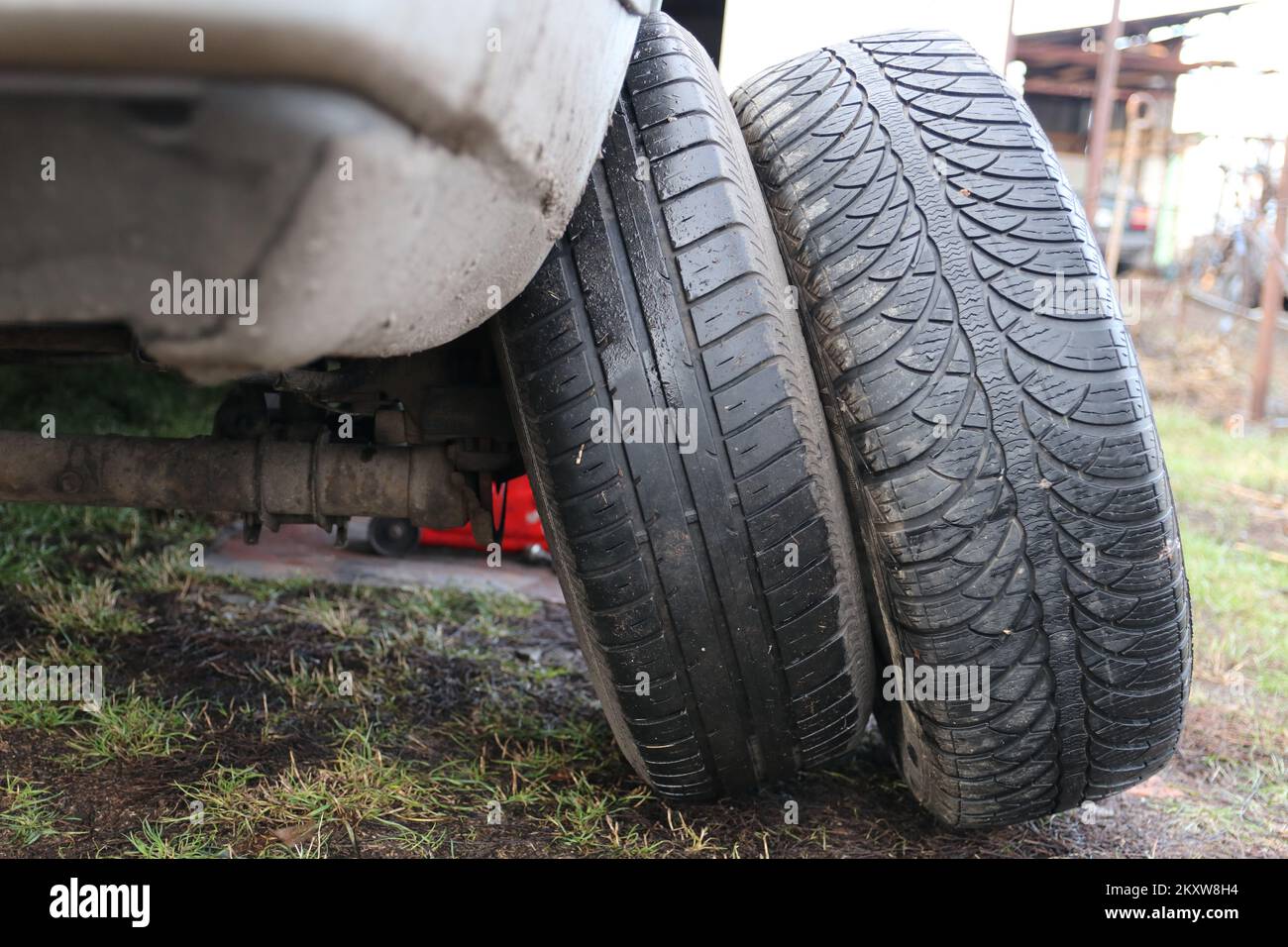Changing car wheels. Replacement of winter and summer tires Stock Photo