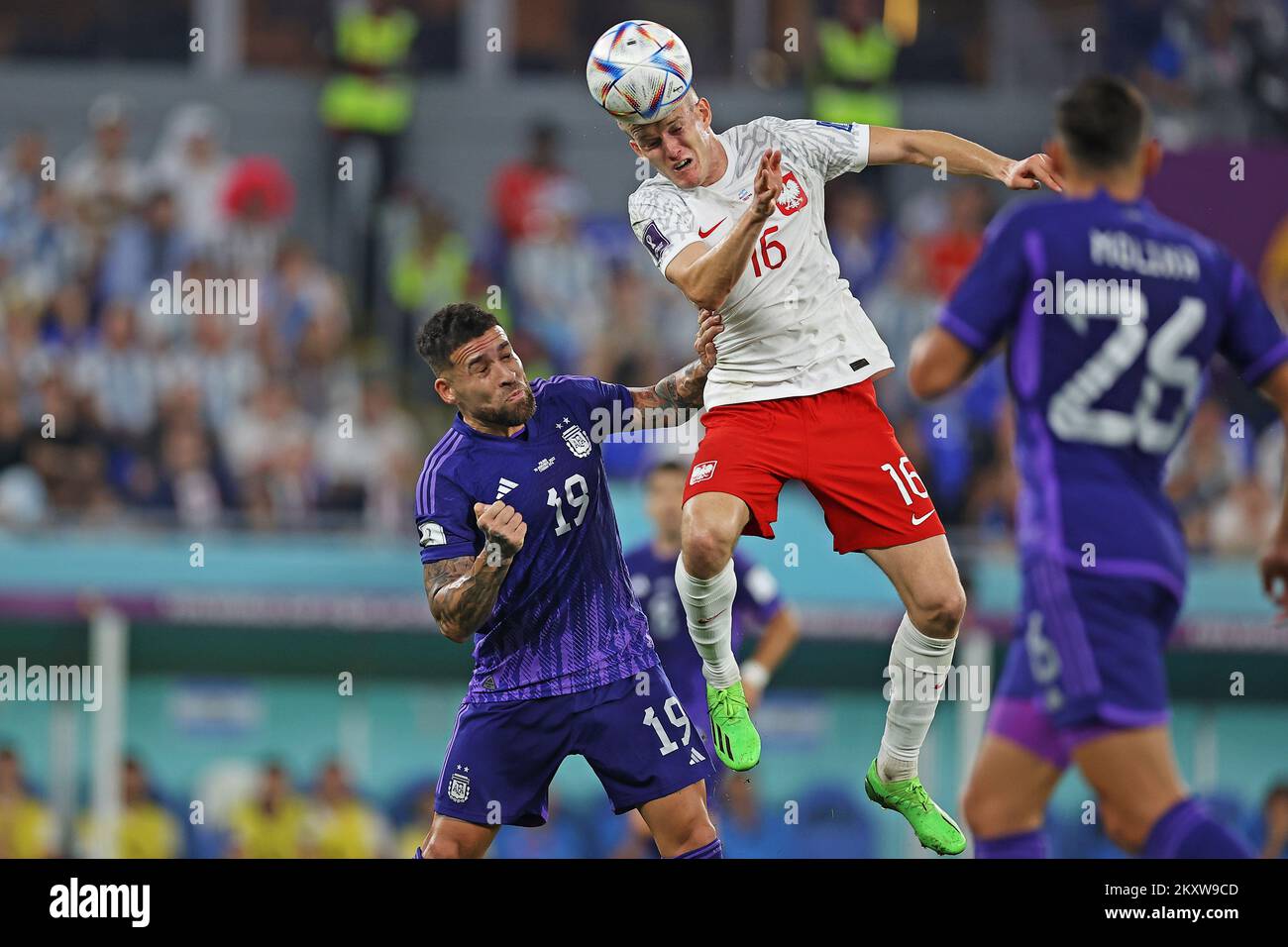 Doha, Qatar. 30th November 2022; Stadium 974, Doha, Qatar; FIFA World Cup Football, Poland versus Argentina; Karol Swiderski of Poland wins a header from Nicolás Otamendi of Argentina Credit: Action Plus Sports Images/Alamy Live News Stock Photo