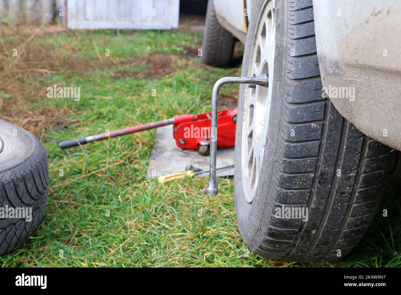 Changing car wheels. Replacement of winter and summer tires Stock Photo
