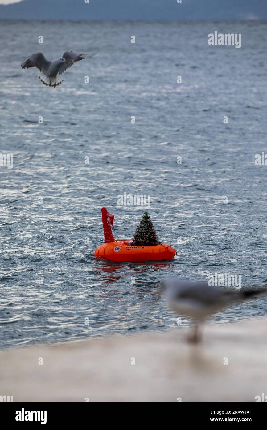 An ornate Christmas tree floats in the sea in Split on December 24