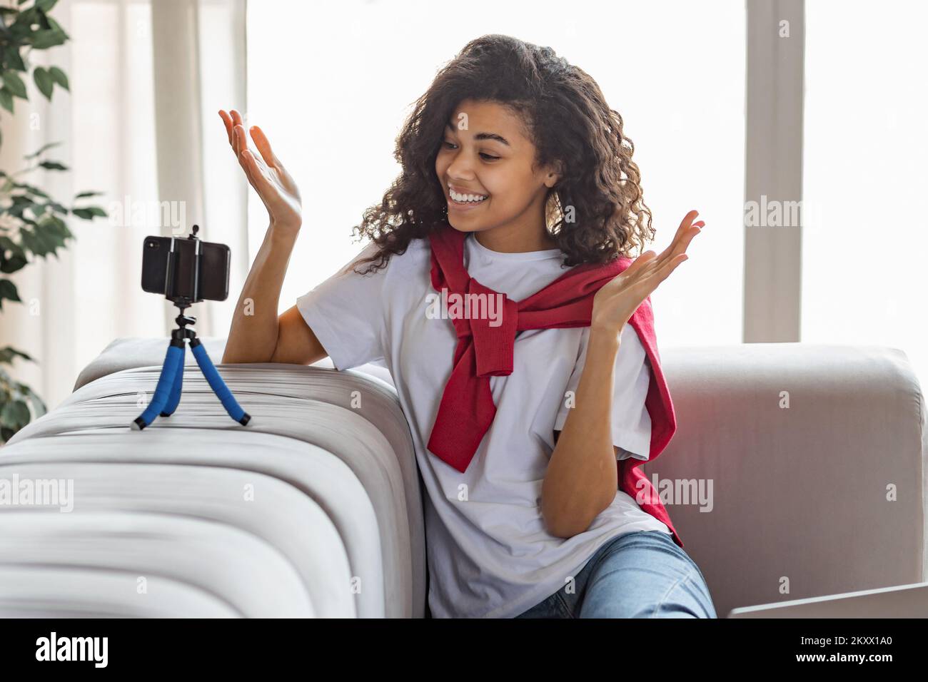 Young attractive African American woman blogger or vlogger looking at camera and talking to followers Stock Photo