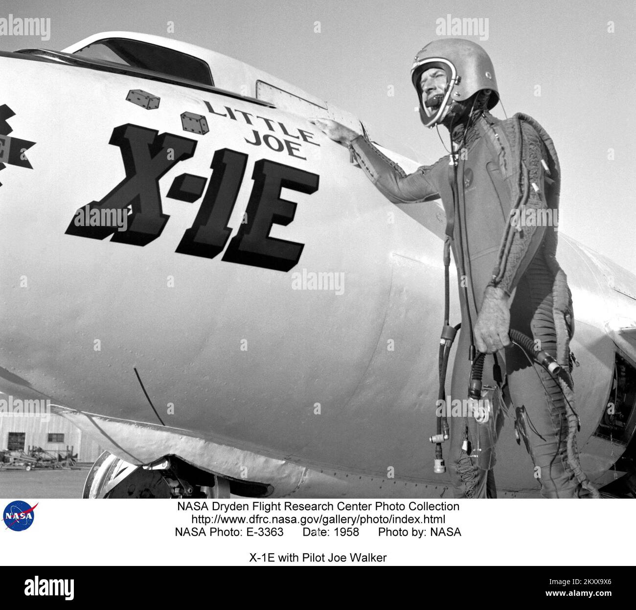 (1958) A photo of the X-1E with pilot Joe Walker suited up at the NASA High-Speed Flight Station, Edwards, California. The dice and 'Little Joe' are prominently displayed under the cockpit area. (Little Joe is a dice player's slang term for two deuces.)     Five years later when Walker reached 354,200 feet in the X-15, that aircraft carried similar artwork - 'Little Joe the II.' Walker is shown in the photo above wearing an early partial pressure suit. This protected the pilot if cockpit pressure was lost above 50,000 feet. Stock Photo
