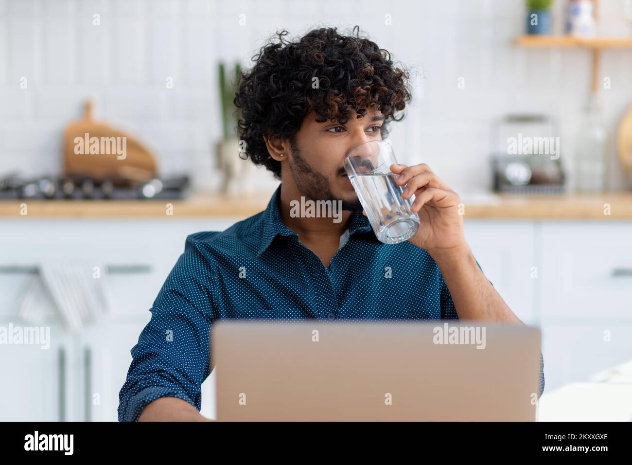 male freelancer or employee sitting at workplace, coworking. man using laptop computer working at home Stock Photo