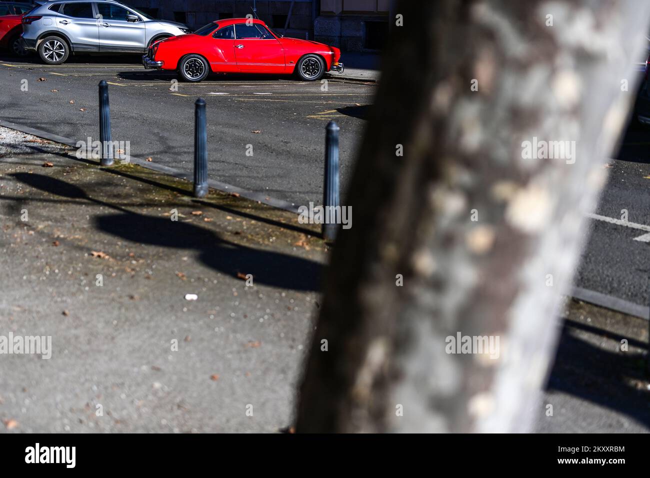 The striking red car VW Karmann Ghia parked in front of the Danish