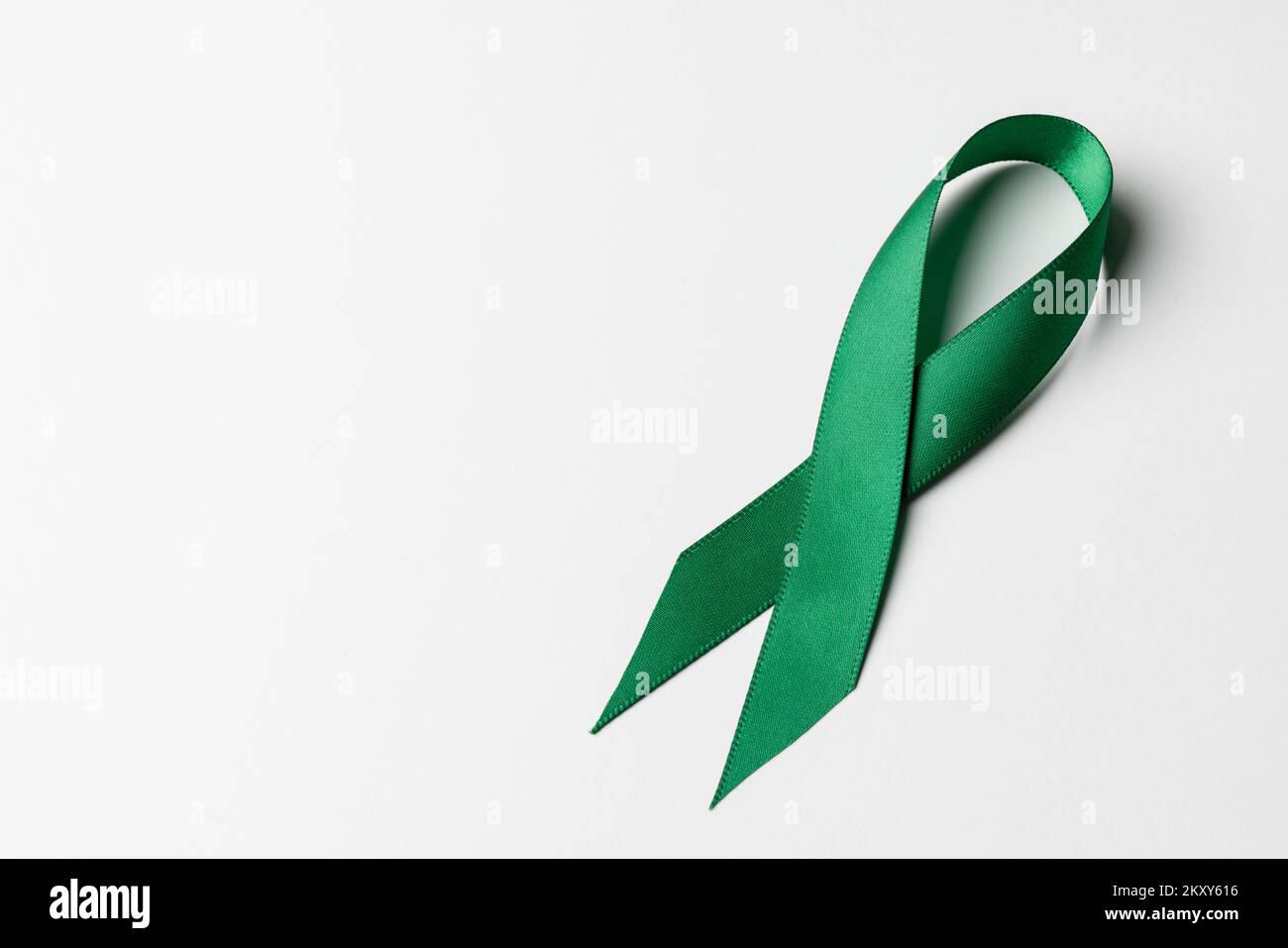 Close up of green ribbon on white background with copy space Stock Photo