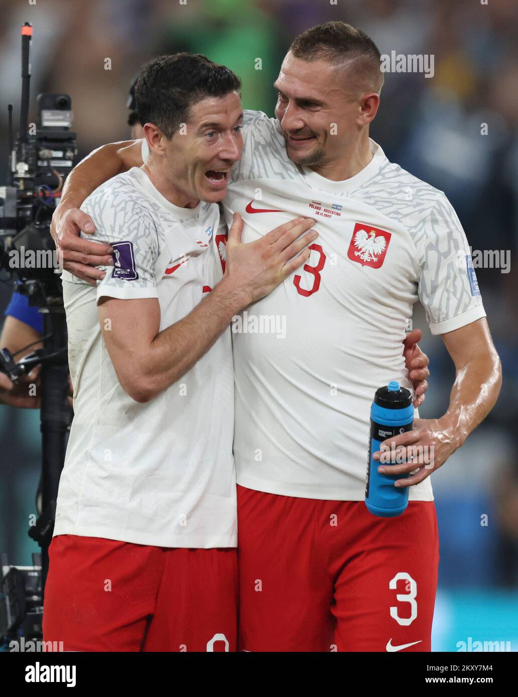 Doha, Qatar. 30th Nov, 2022. Robert Lewandowski (L) and Artur Jedrzejczyk of Poland celebrate their team advancing to the round of 16 after the Group C match between Poland and Argentina at the 2022 FIFA World Cup at Stadium 974 in Doha, Qatar, Nov. 30, 2022. Credit: Cao Can/Xinhua/Alamy Live News Stock Photo