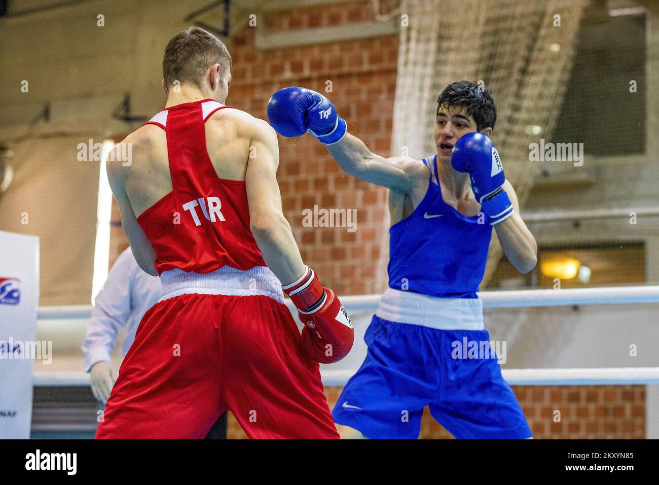 Chess boxers Arik Braun (R) and Felix Bartels sit in front of a chequer  board during the Chess Boxing Championships in Berlin, Germany, 28 July  2012. The chess boxing event took place